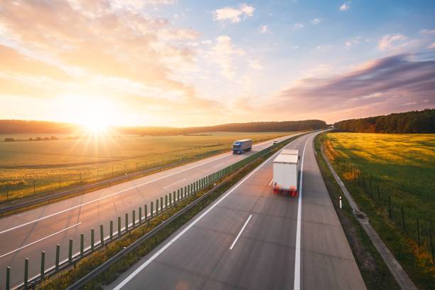 TRUCK ON HIGHWAY SUNSET